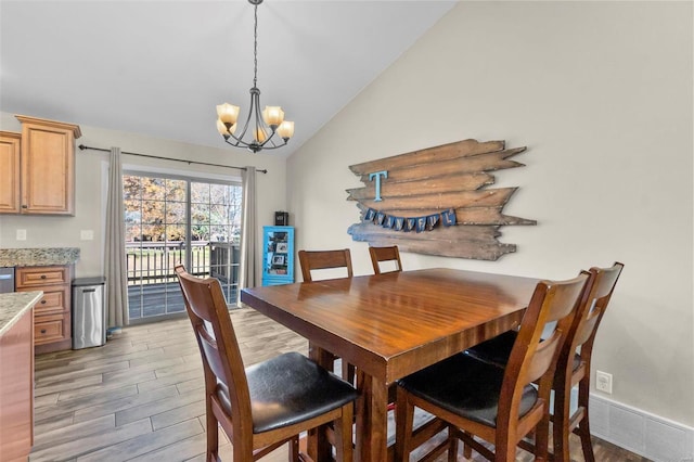 dining space with a notable chandelier, dark hardwood / wood-style flooring, and vaulted ceiling