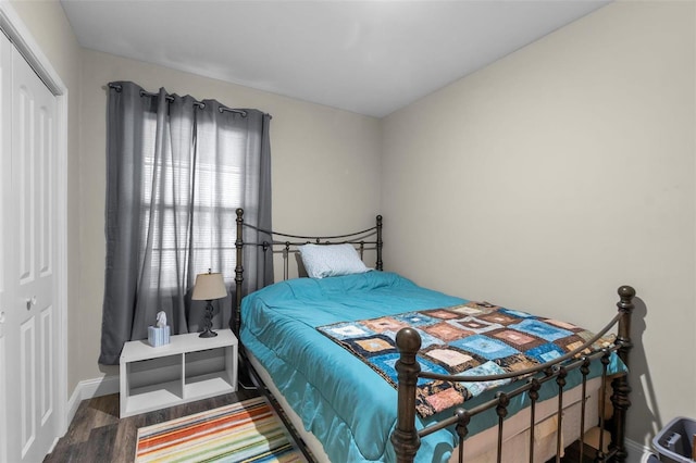 bedroom featuring dark hardwood / wood-style flooring and a closet