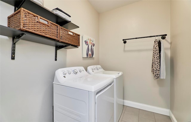 washroom with light tile patterned floors and washer and dryer