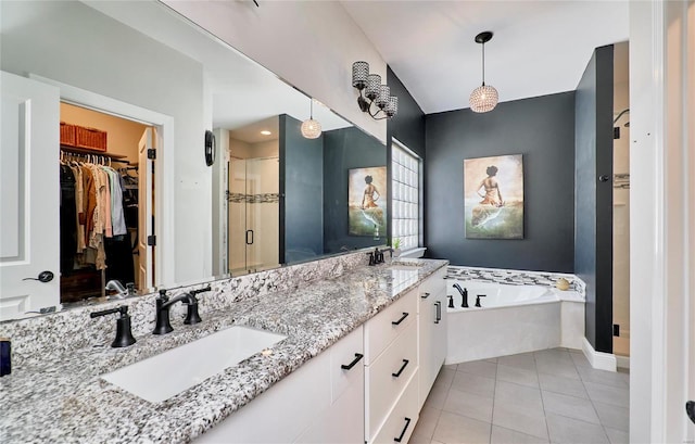 bathroom featuring tile patterned flooring, vanity, and shower with separate bathtub