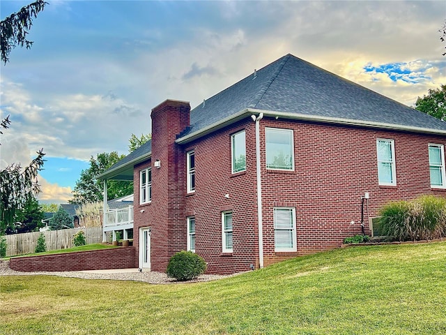 view of home's exterior with a lawn