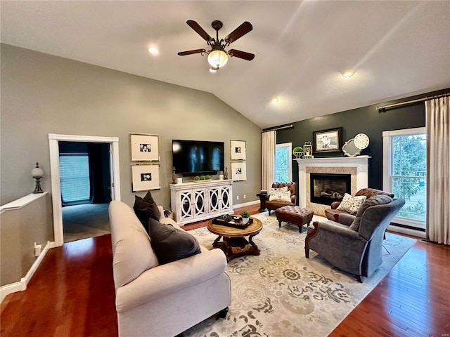 living room with hardwood / wood-style floors, ceiling fan, and lofted ceiling