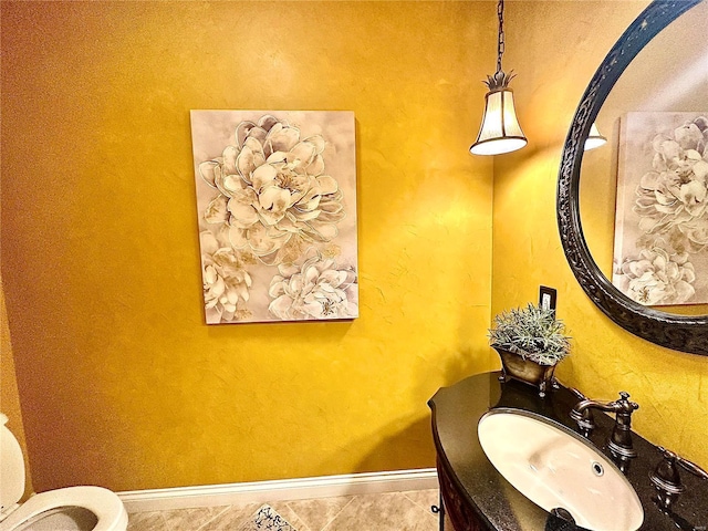 bathroom with tile patterned flooring, vanity, and toilet