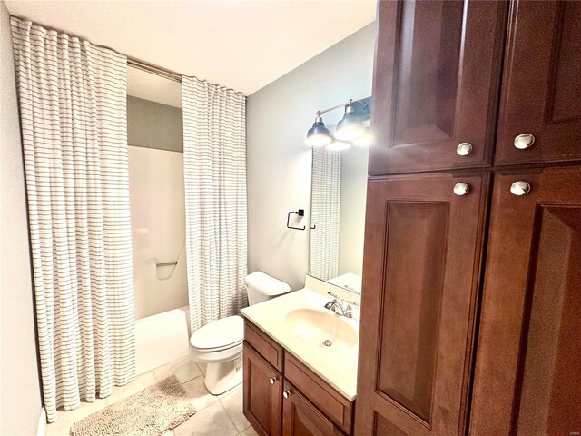 full bathroom featuring tile patterned floors, shower / bath combo with shower curtain, vanity, and toilet