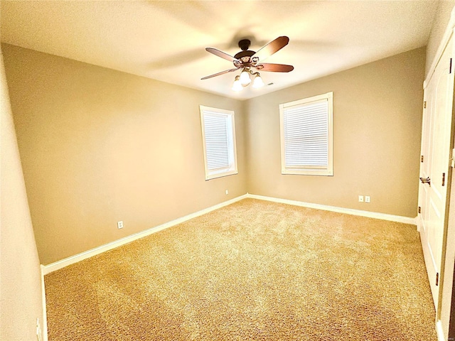 carpeted empty room featuring ceiling fan