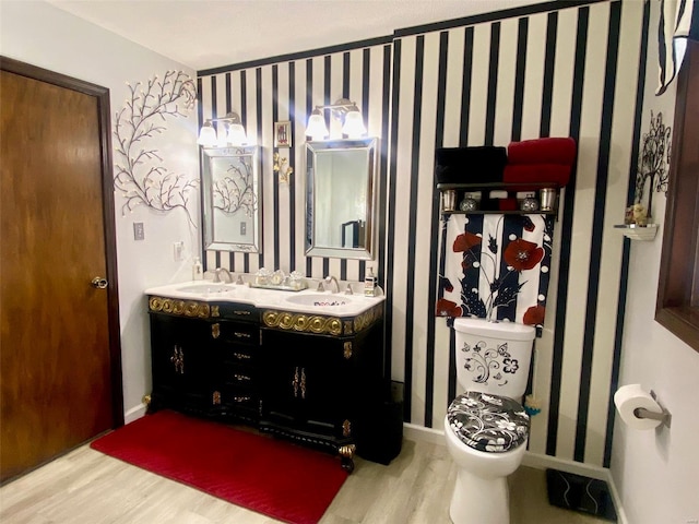 bathroom featuring hardwood / wood-style flooring, vanity, and toilet