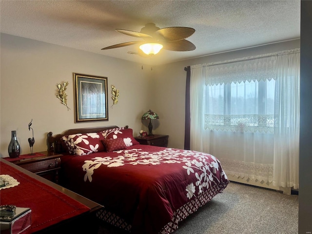 carpeted bedroom with a textured ceiling and ceiling fan