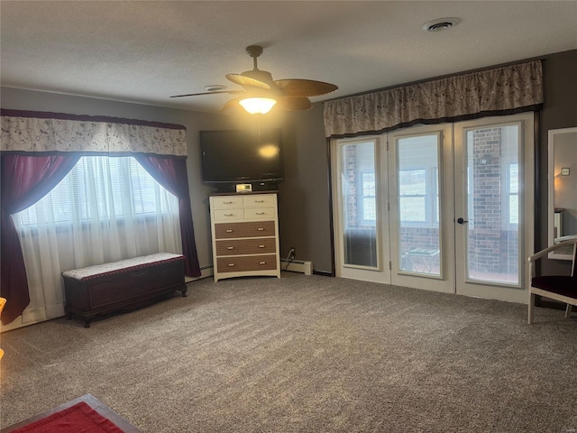 unfurnished bedroom featuring ceiling fan, baseboard heating, carpet floors, a textured ceiling, and access to outside