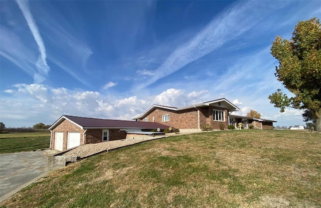 view of side of home featuring a lawn and a garage