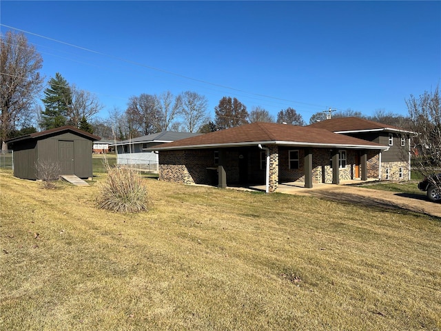 view of side of property featuring a yard and a storage unit