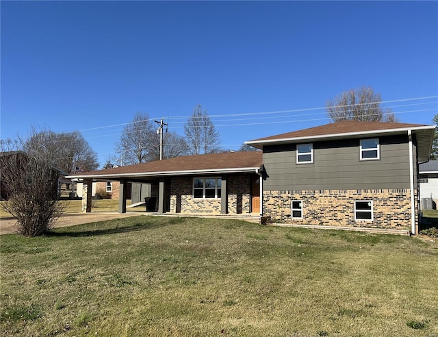 rear view of property with a yard