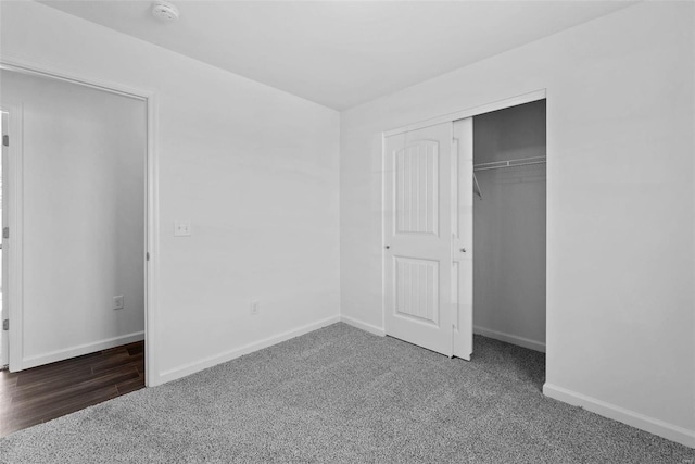 unfurnished bedroom featuring dark wood-type flooring and a closet