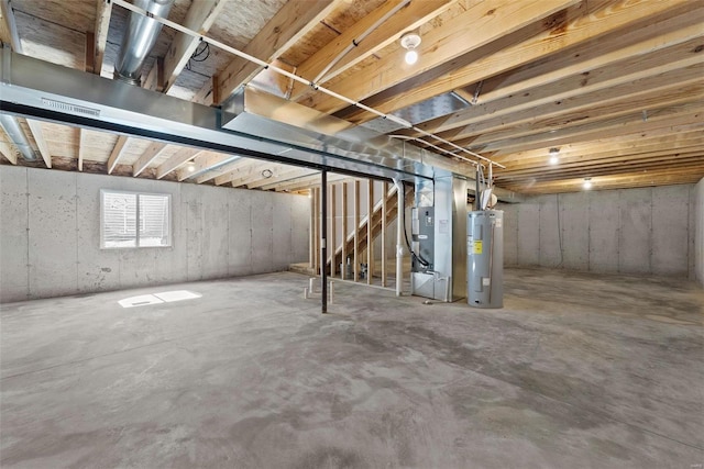 basement featuring heating unit and electric water heater