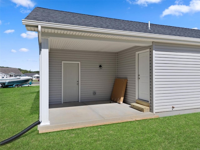 view of exterior entry with a lawn