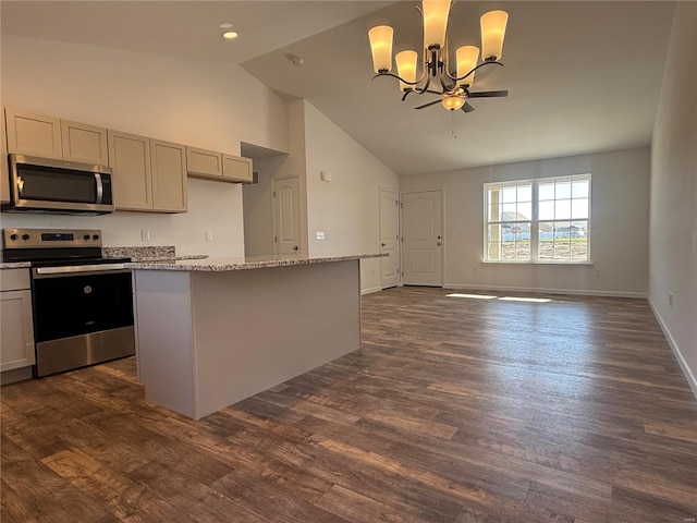 kitchen with dark wood-type flooring, stainless steel appliances, an inviting chandelier, light stone counters, and pendant lighting