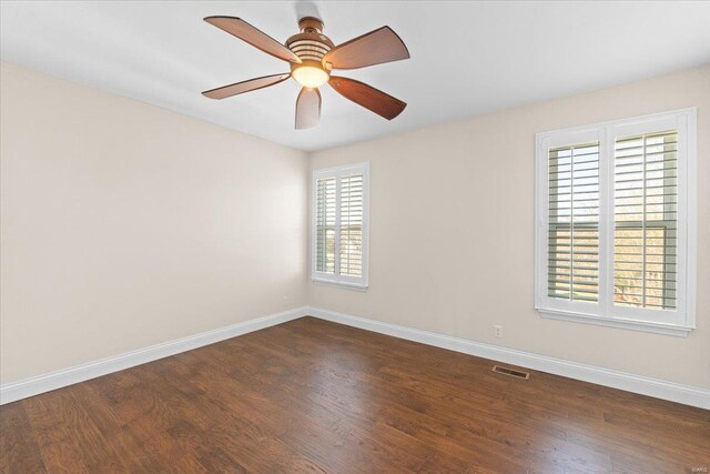 unfurnished room featuring dark hardwood / wood-style floors and ceiling fan