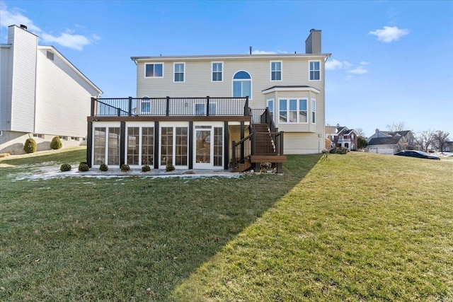 rear view of property with a sunroom and a yard