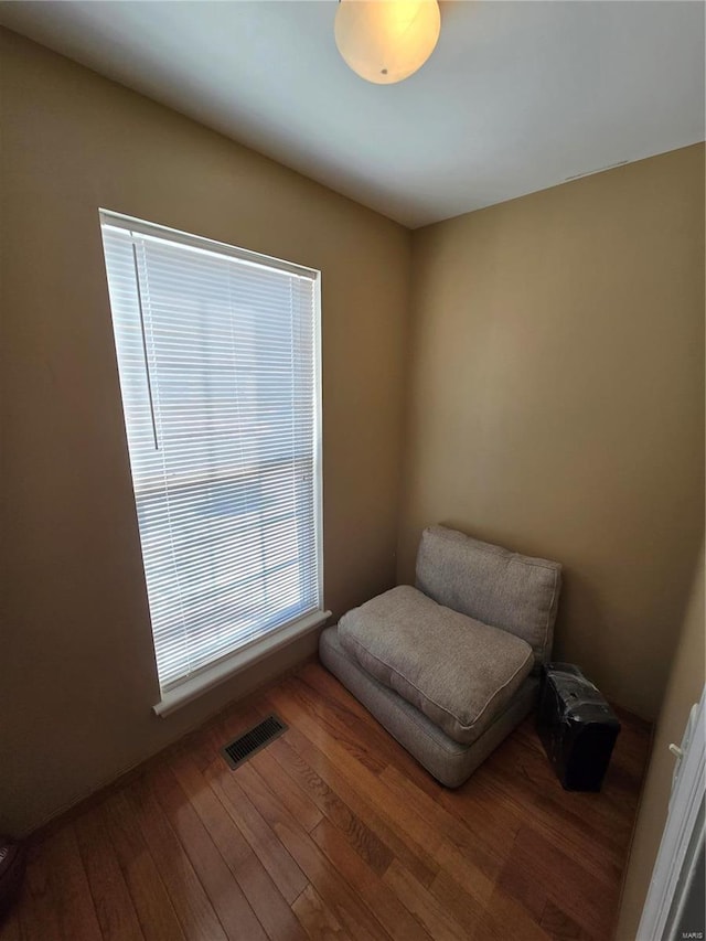 sitting room with wood-type flooring