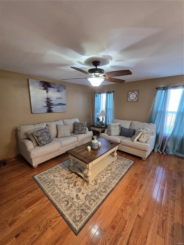 living room with ceiling fan and wood-type flooring