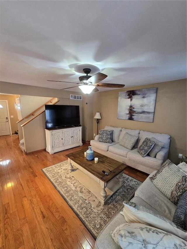 living room featuring ceiling fan and light wood-type flooring