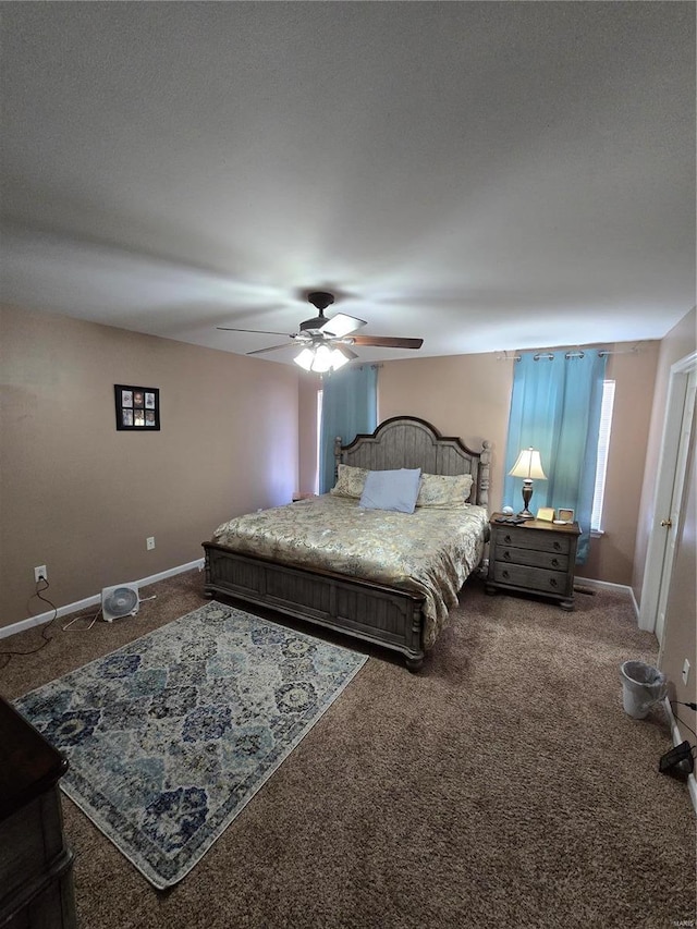 bedroom featuring ceiling fan and carpet