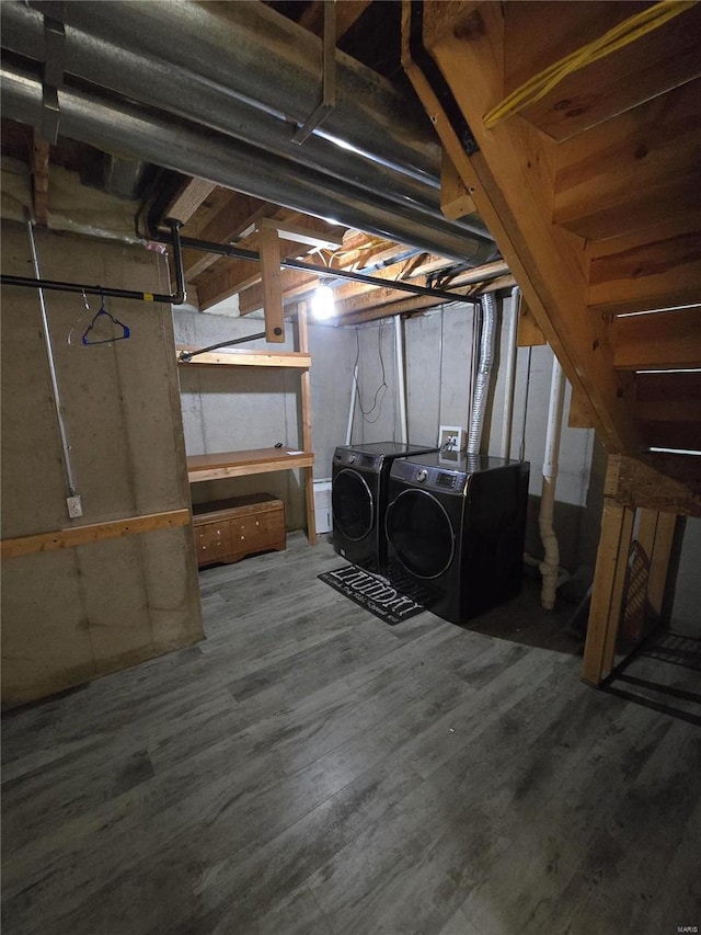 basement with hardwood / wood-style floors and washing machine and clothes dryer