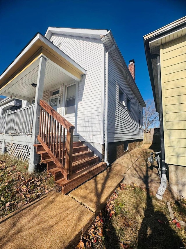 view of side of home with a porch