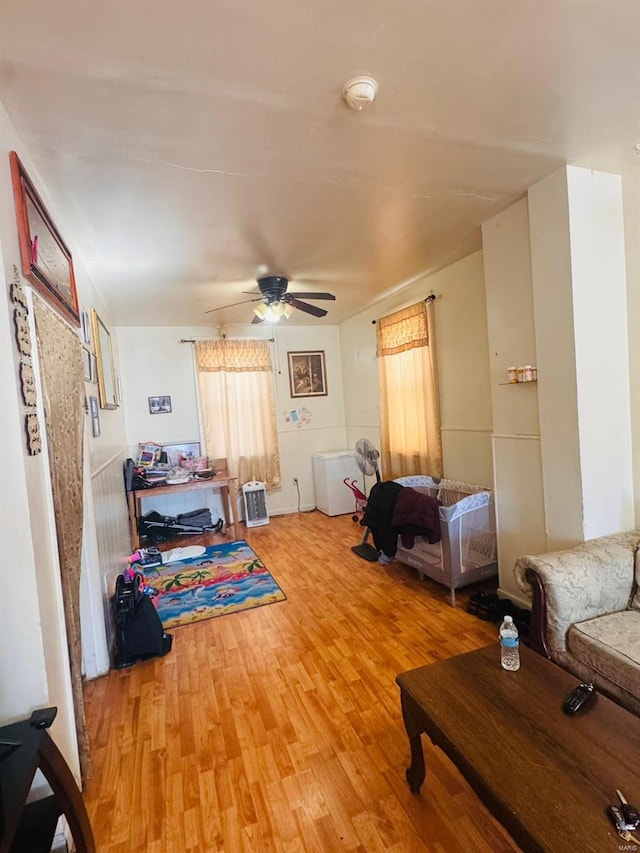 living room featuring ceiling fan and hardwood / wood-style flooring