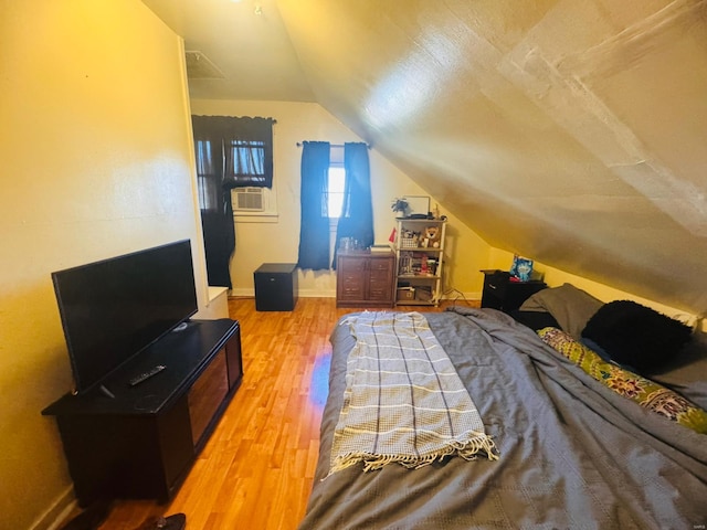 bedroom featuring lofted ceiling and hardwood / wood-style flooring