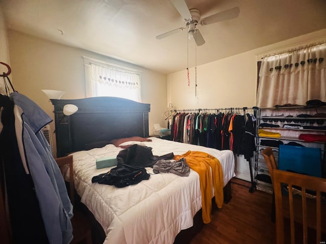 bedroom with ceiling fan and dark hardwood / wood-style flooring