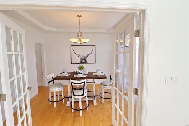 dining room with hardwood / wood-style flooring and french doors