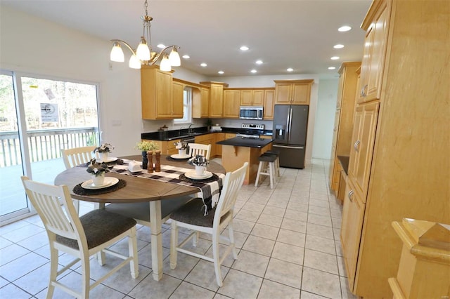 tiled dining room with a chandelier and sink