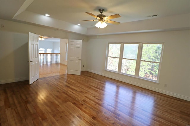 spare room featuring ceiling fan and dark hardwood / wood-style flooring