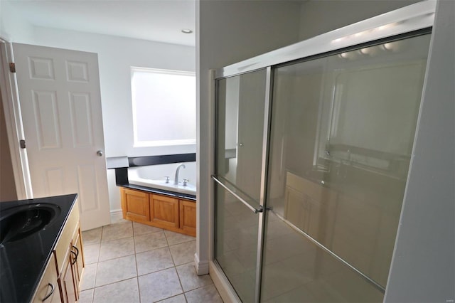 bathroom featuring tile patterned flooring, vanity, and separate shower and tub