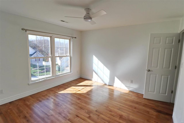 spare room with wood-type flooring and ceiling fan