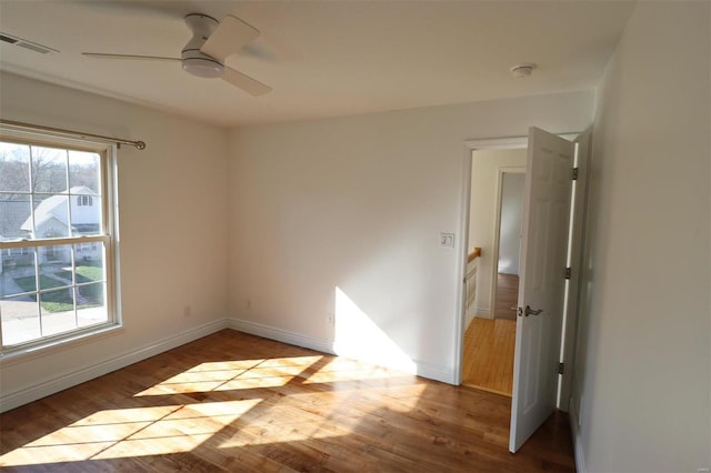 spare room featuring ceiling fan and light hardwood / wood-style flooring