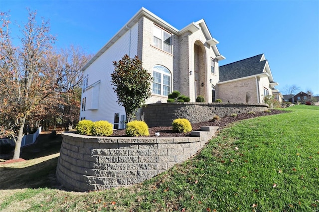 view of home's exterior with a yard