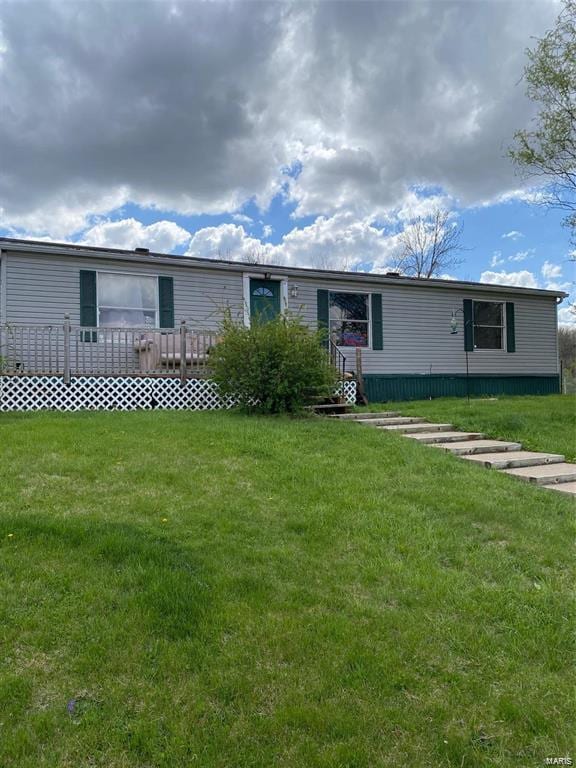 rear view of house featuring a yard and a wooden deck