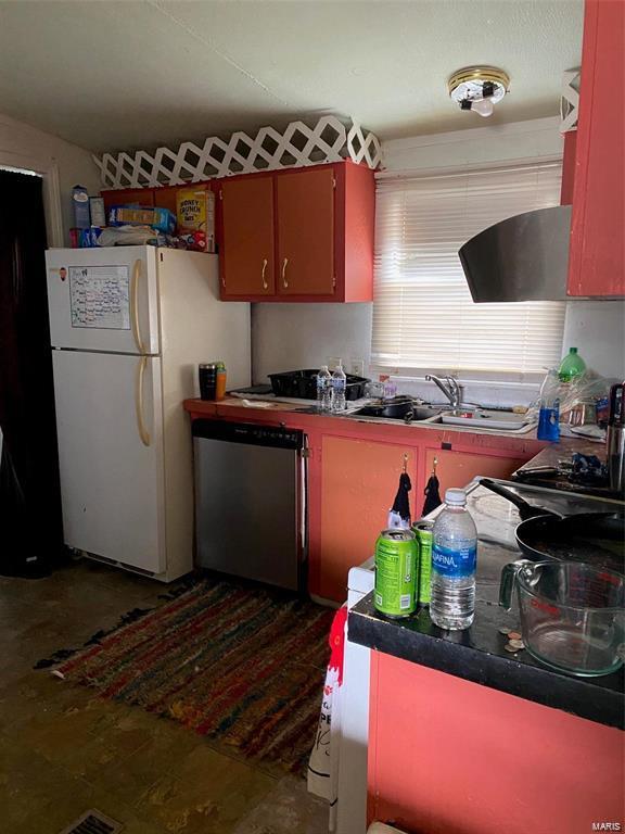 kitchen featuring sink, stainless steel dishwasher, and white refrigerator