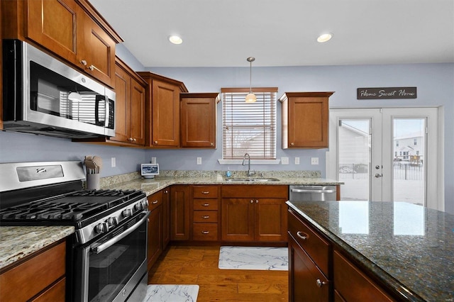 kitchen featuring french doors, sink, a wealth of natural light, appliances with stainless steel finishes, and dark hardwood / wood-style flooring