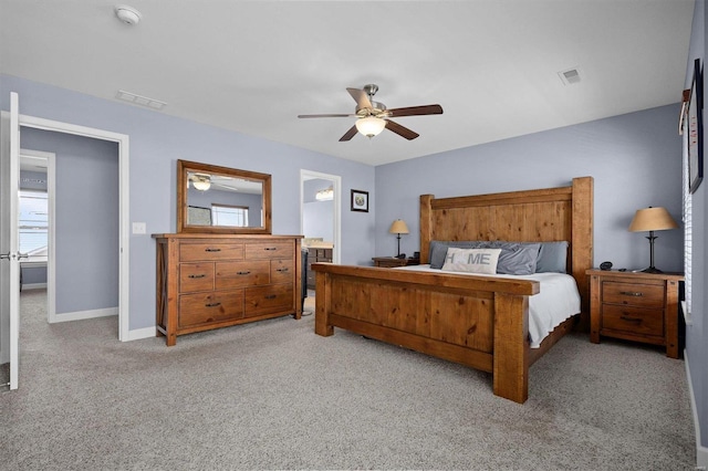 carpeted bedroom featuring ensuite bathroom and ceiling fan