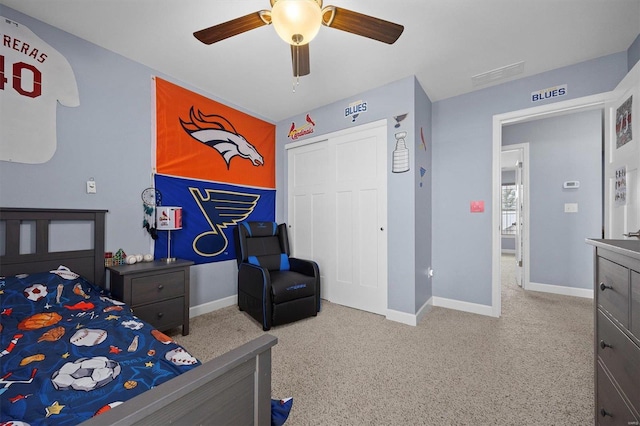 carpeted bedroom featuring ceiling fan and a closet