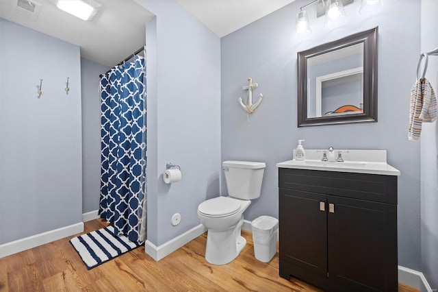 bathroom featuring hardwood / wood-style floors, vanity, and toilet