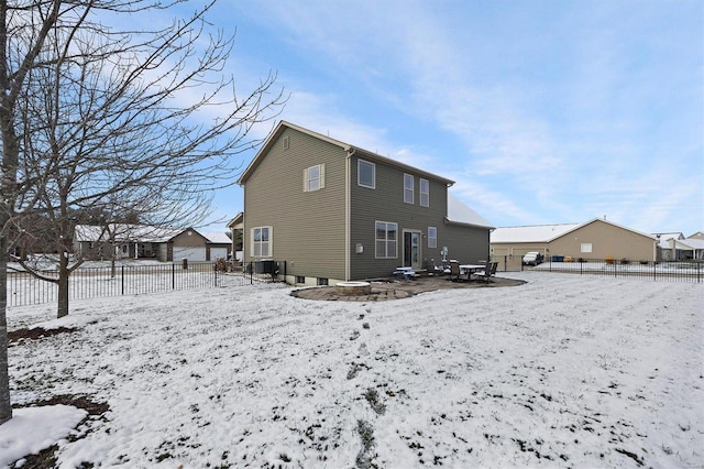 view of snow covered back of property