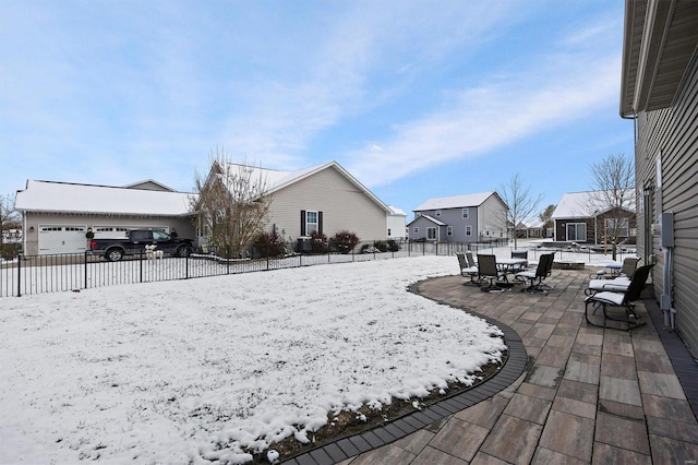 yard layered in snow featuring a patio area