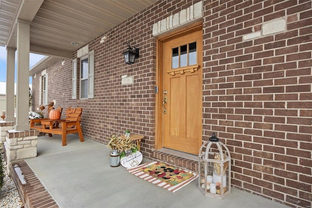 view of exterior entry with covered porch