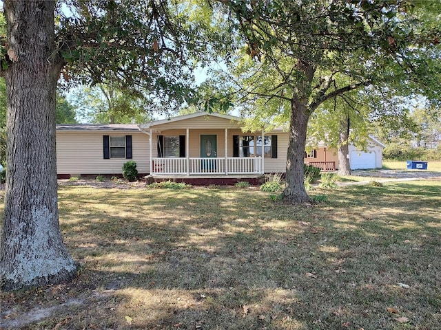 single story home with an outbuilding, a garage, and a front yard