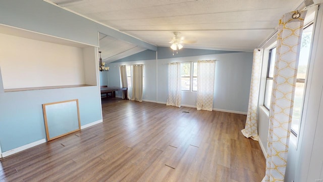 spare room with vaulted ceiling with beams, ceiling fan with notable chandelier, and hardwood / wood-style flooring