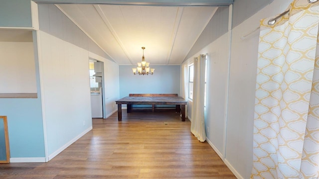 hall with light hardwood / wood-style floors, vaulted ceiling, crown molding, and a chandelier