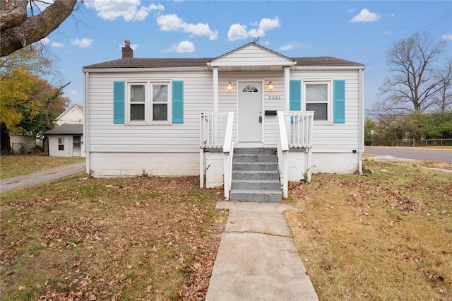 bungalow-style house with a front yard